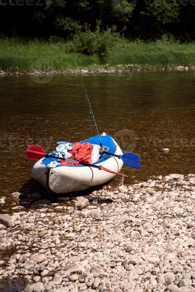 A kayak on the shore of a river photo