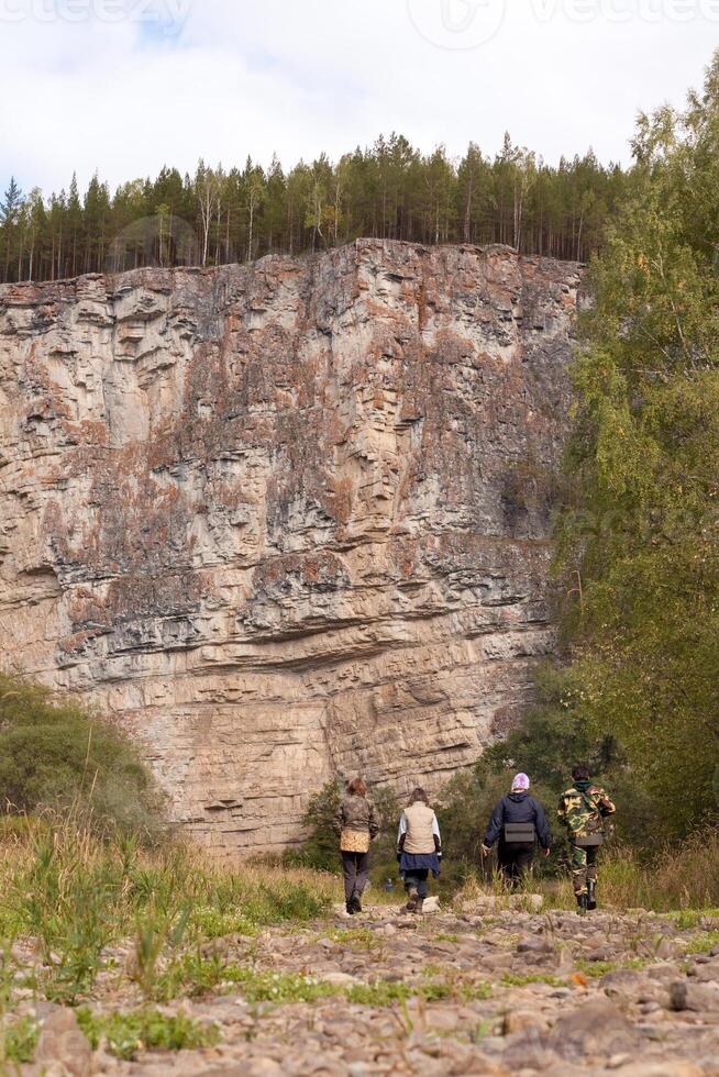 A group of people walking on a trail photo