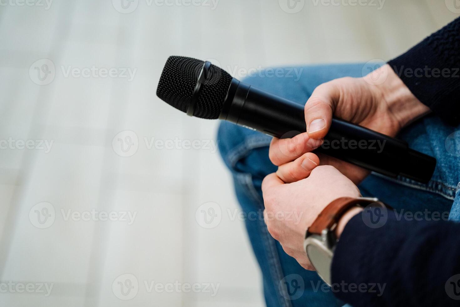 A person holding a microphone in their hand photo