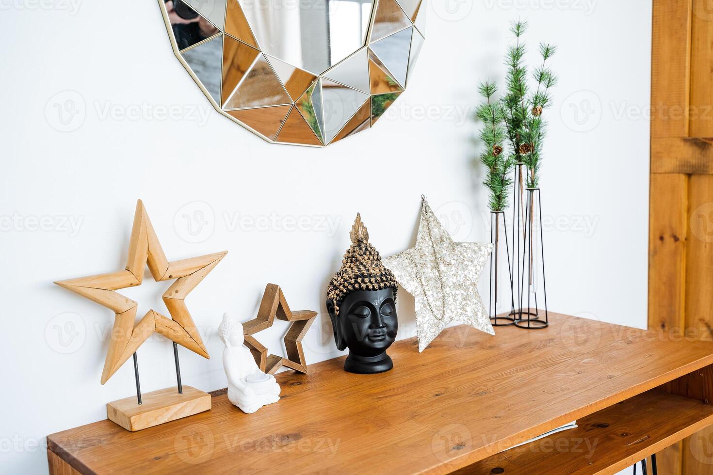 A wooden table with a mirror, star and a christmas tree photo