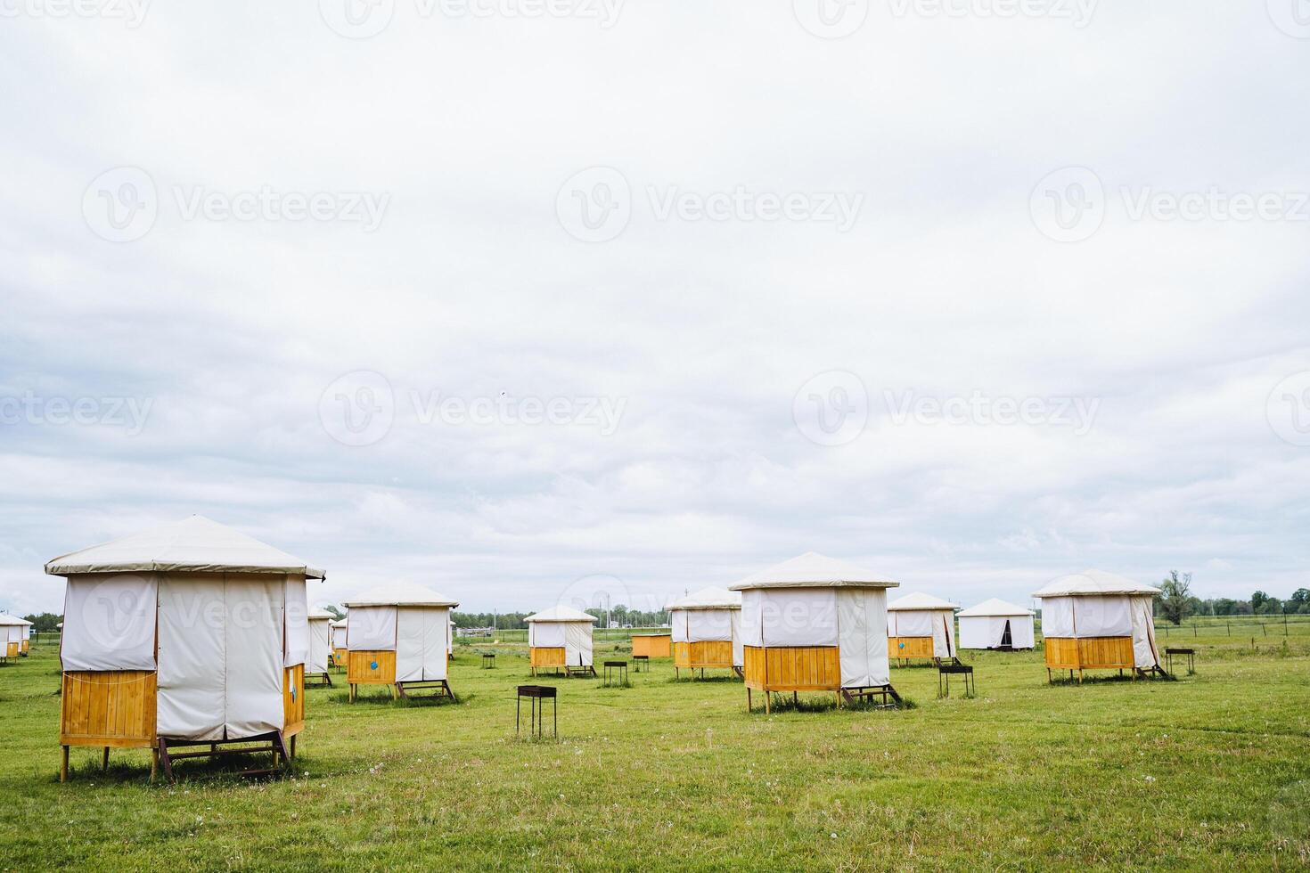 A field with many tents sitting on top of it photo