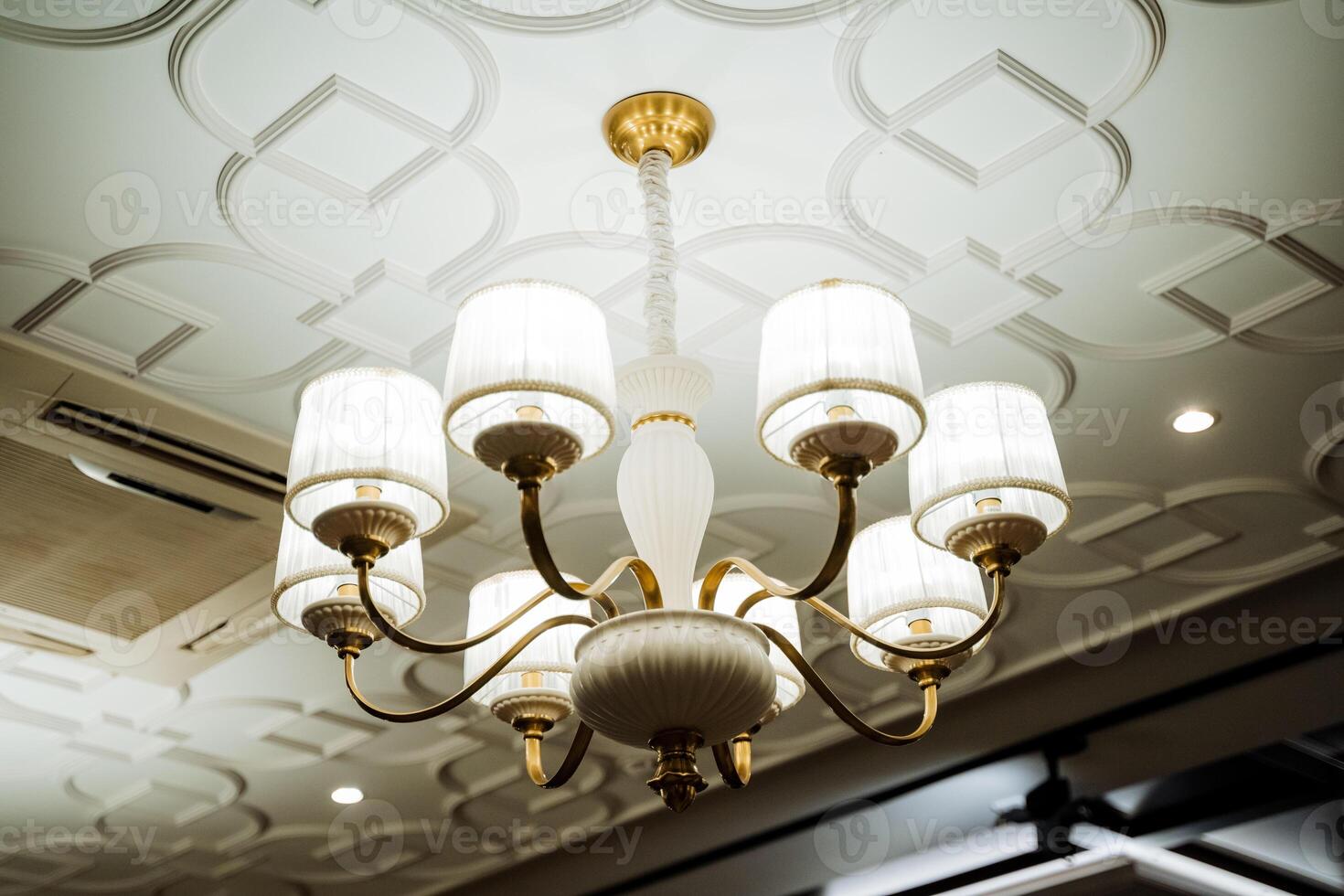 A chandelier with white lights and gold accents photo
