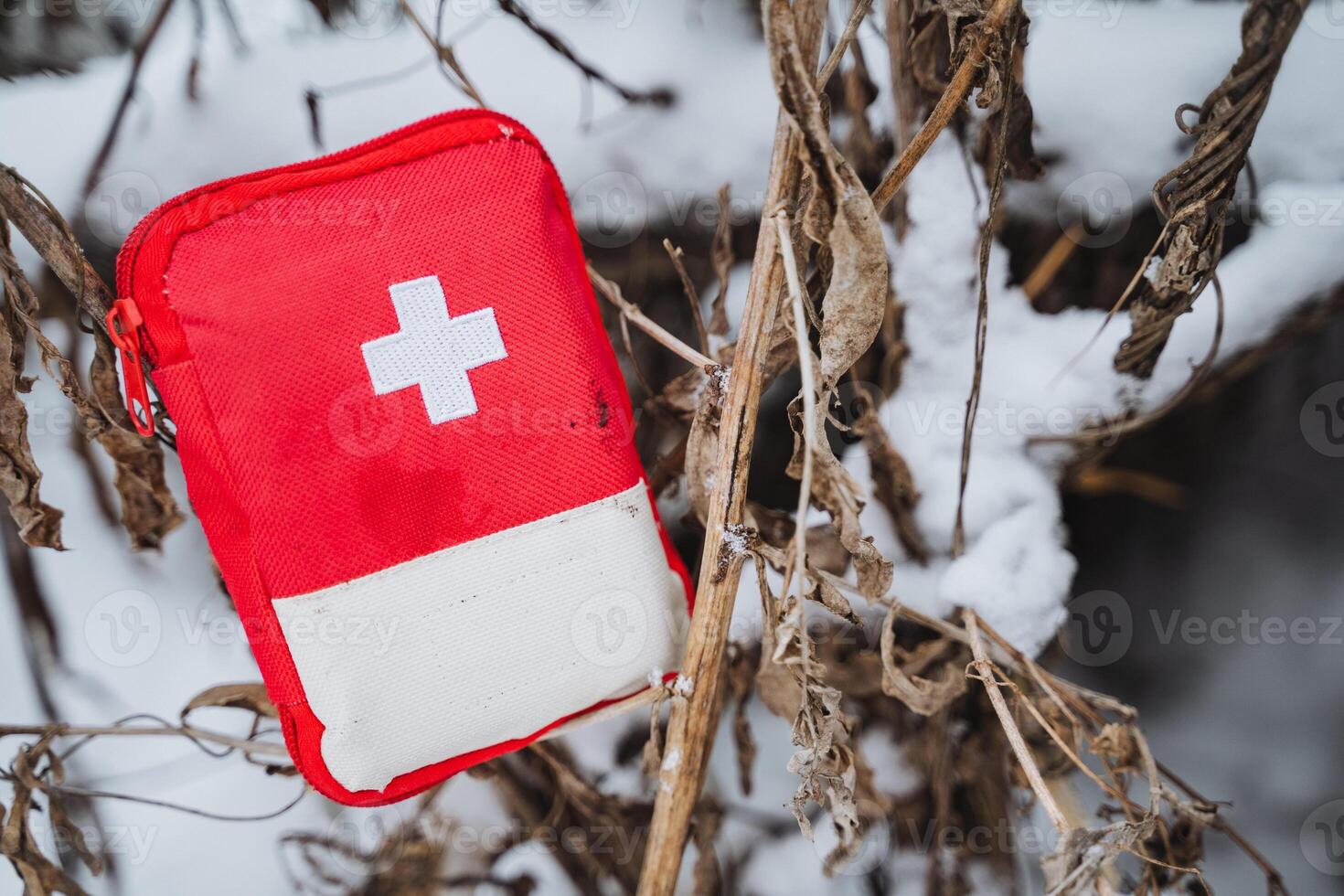 A red first aid kit in the snow photo