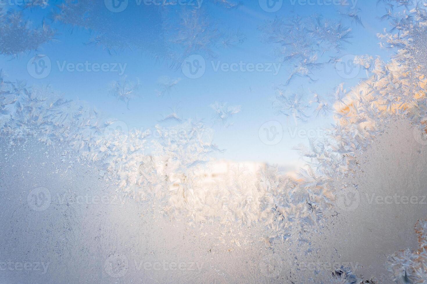 Frost on a window with blue sky in the background photo