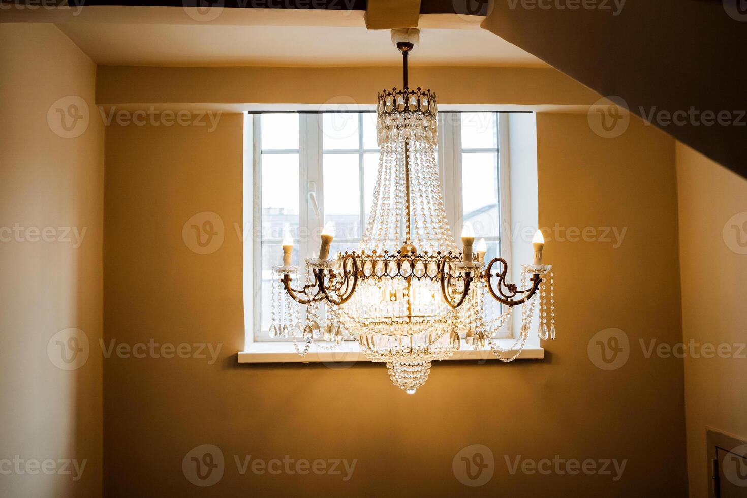 A chandelier hanging from the ceiling in a room photo