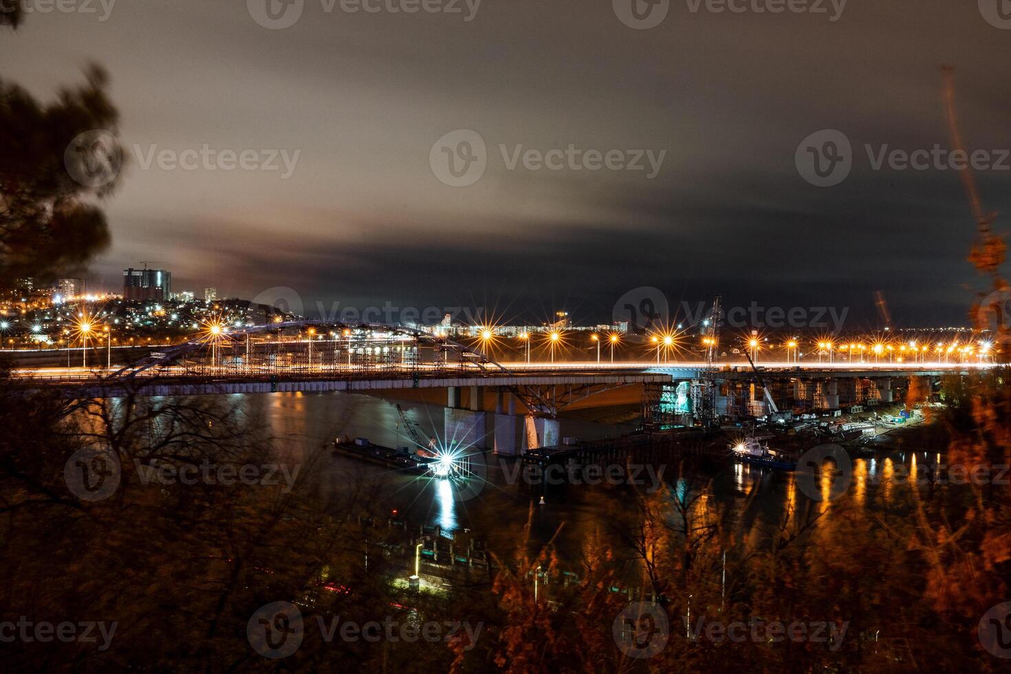 A bridge over a river at night photo