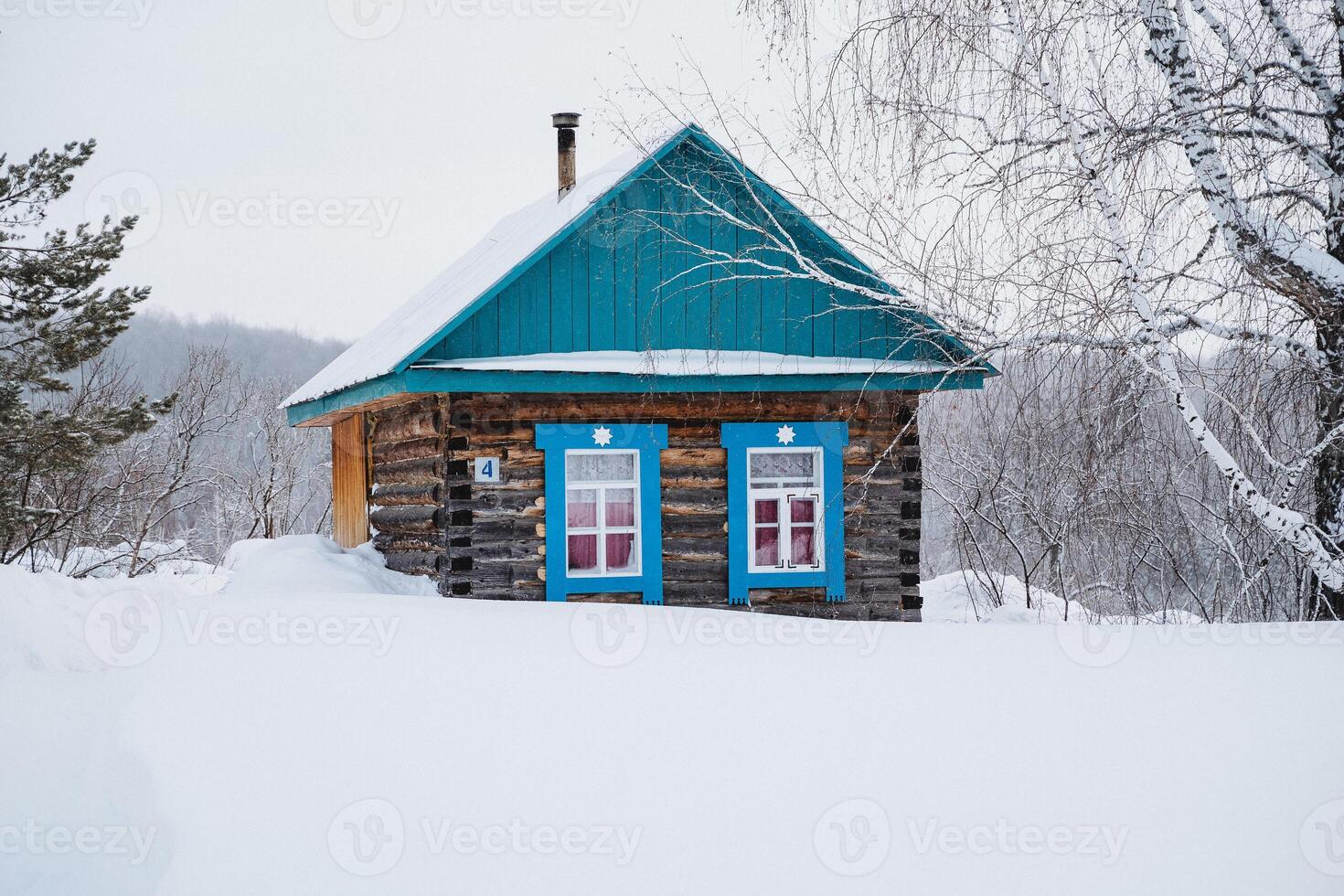 A small wooden house with blue windows photo