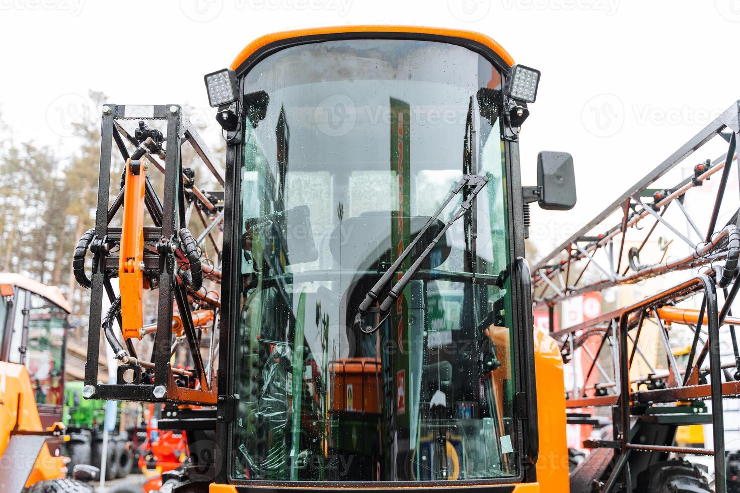 A close up of a tractor with a large sprayer attached photo