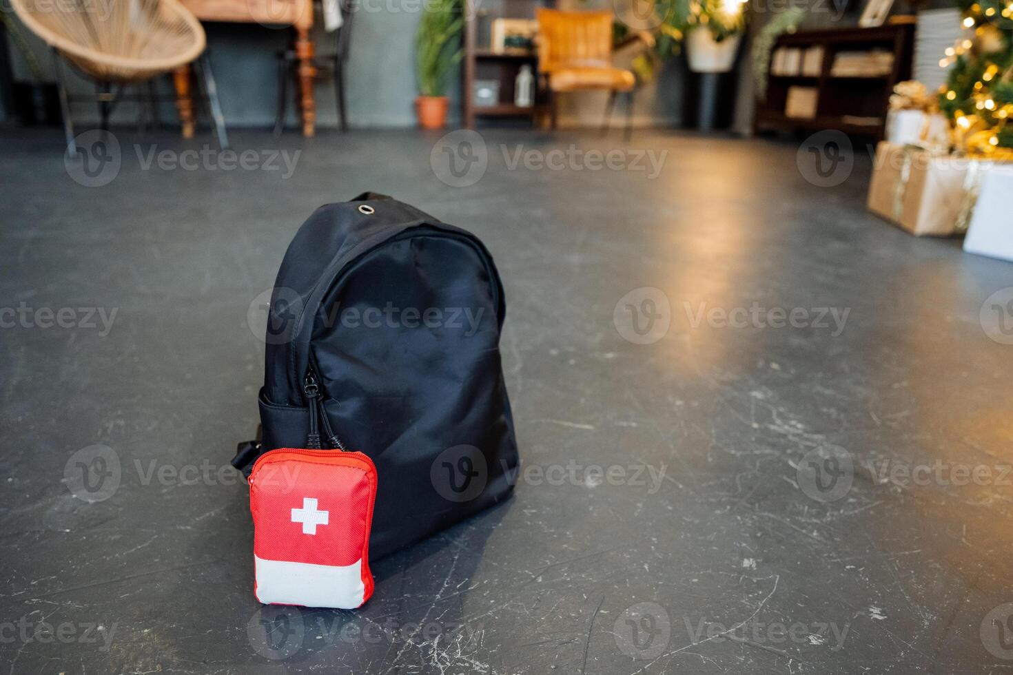 A backpack and a red cross on the floor photo