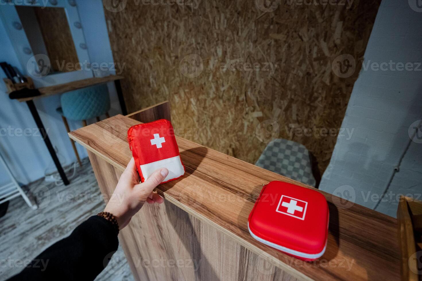 A person holding a red first aid box photo