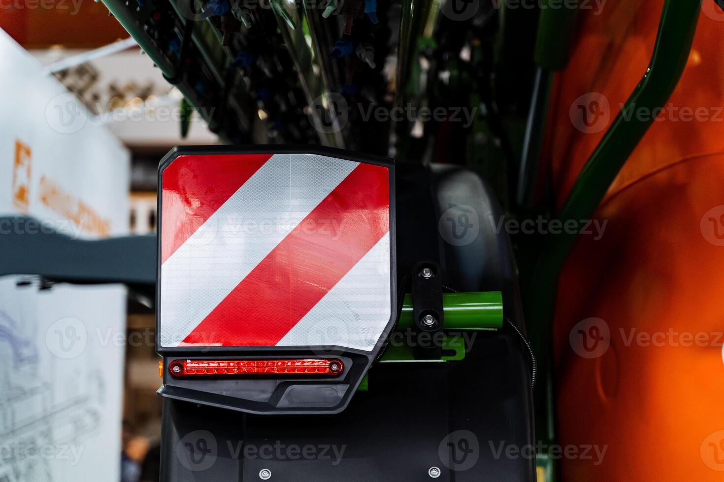 A close up of a tractor with a red and white stripe photo