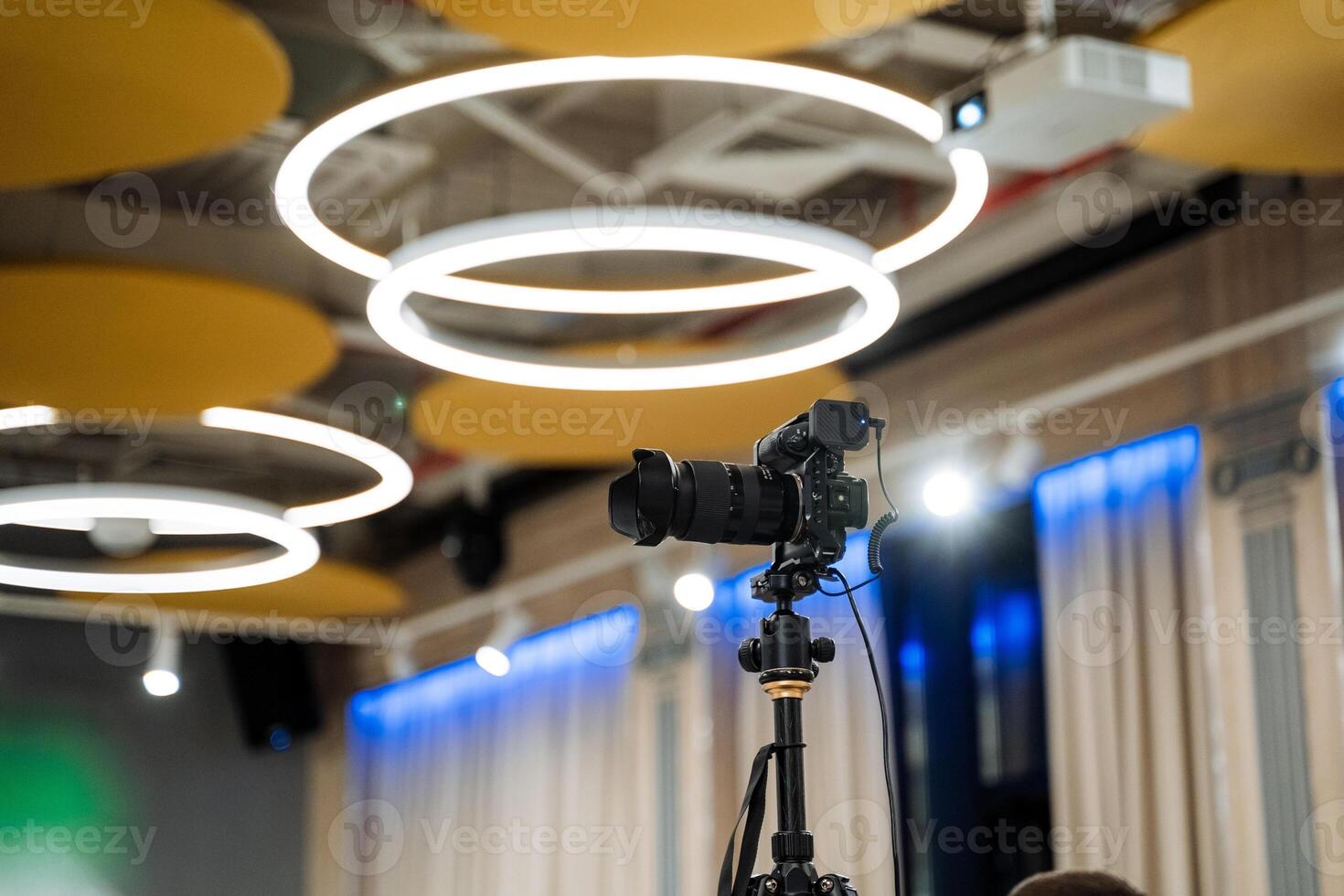 A camera is set up in front of a large room photo