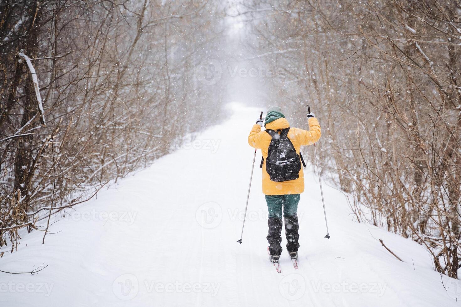 A person is skiing down a snowy path photo