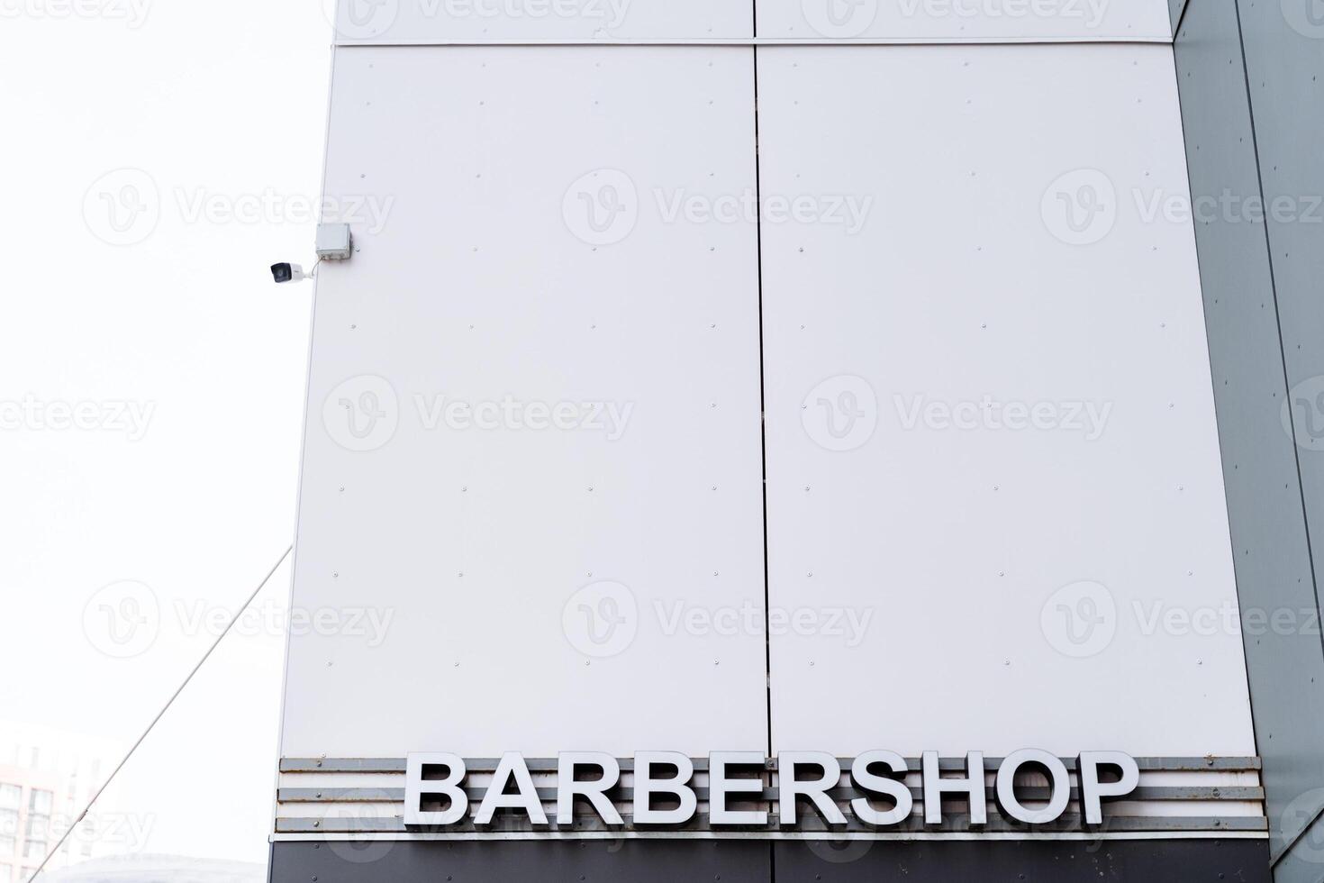 A sign on a building that says barbershop photo