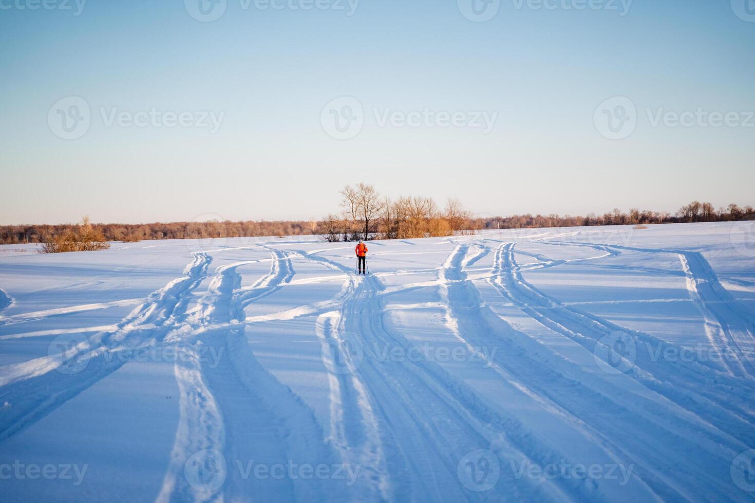 A person is skiing down a snowy field photo