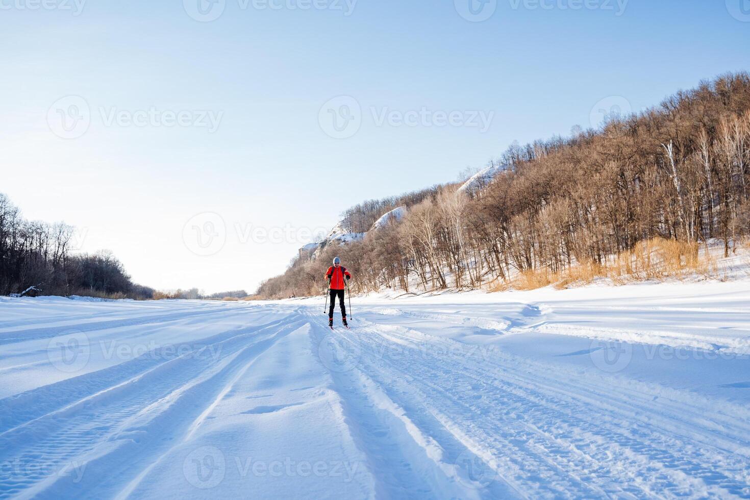 A person is cross country skiing on a snowy road photo