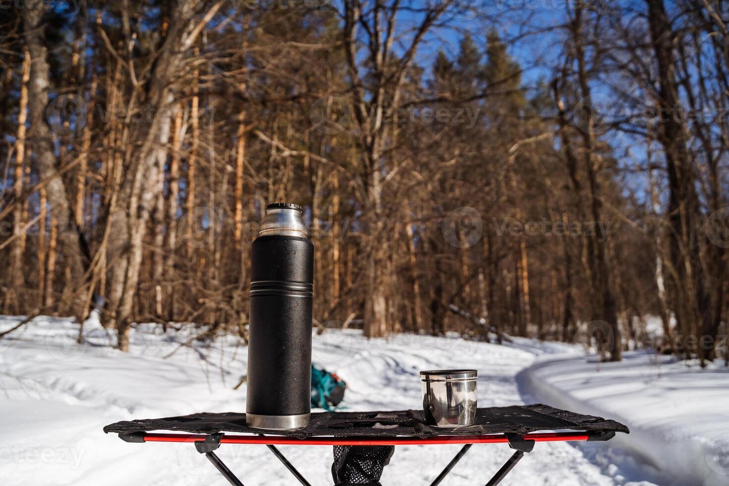 A coffee mug and a thermos on a sled photo