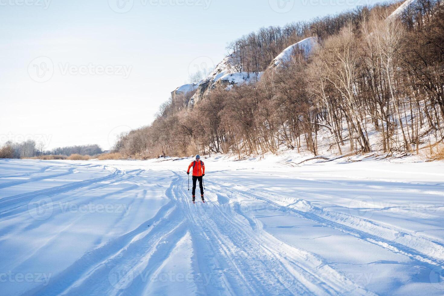 A person is cross country skiing on a snowy trail photo