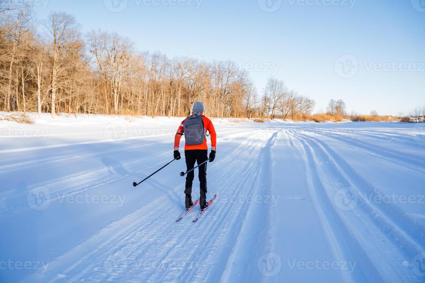A person cross country skiing on a snowy trail photo