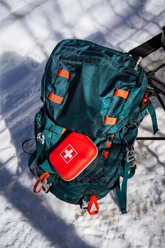 A backpack with a red first aid kit on it photo