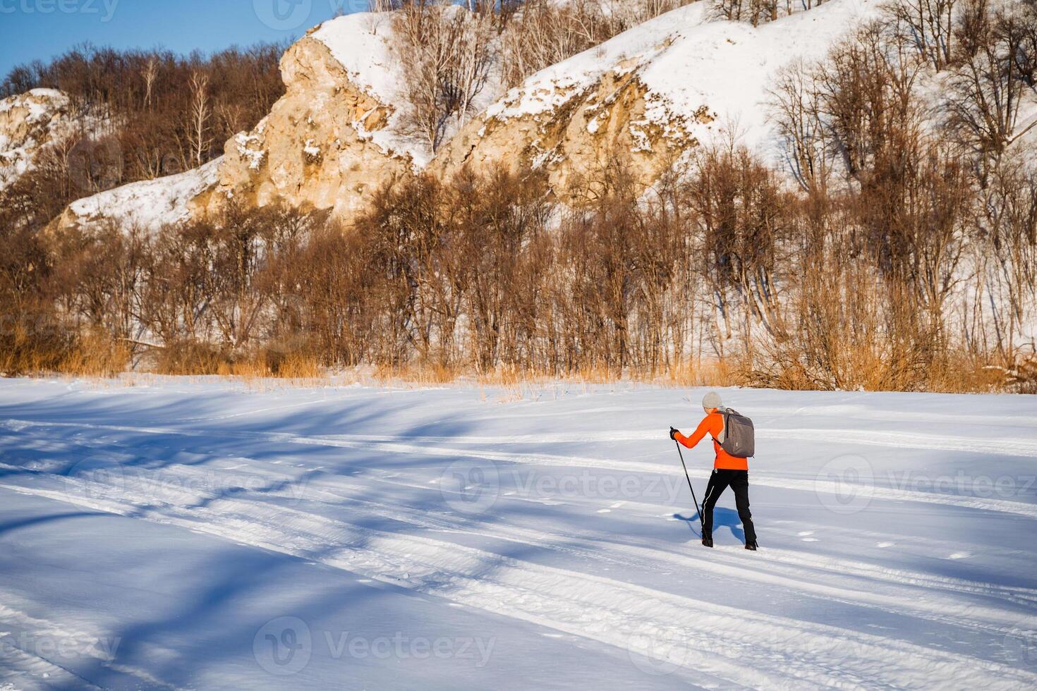 A person cross country skiing on a snowy slope photo