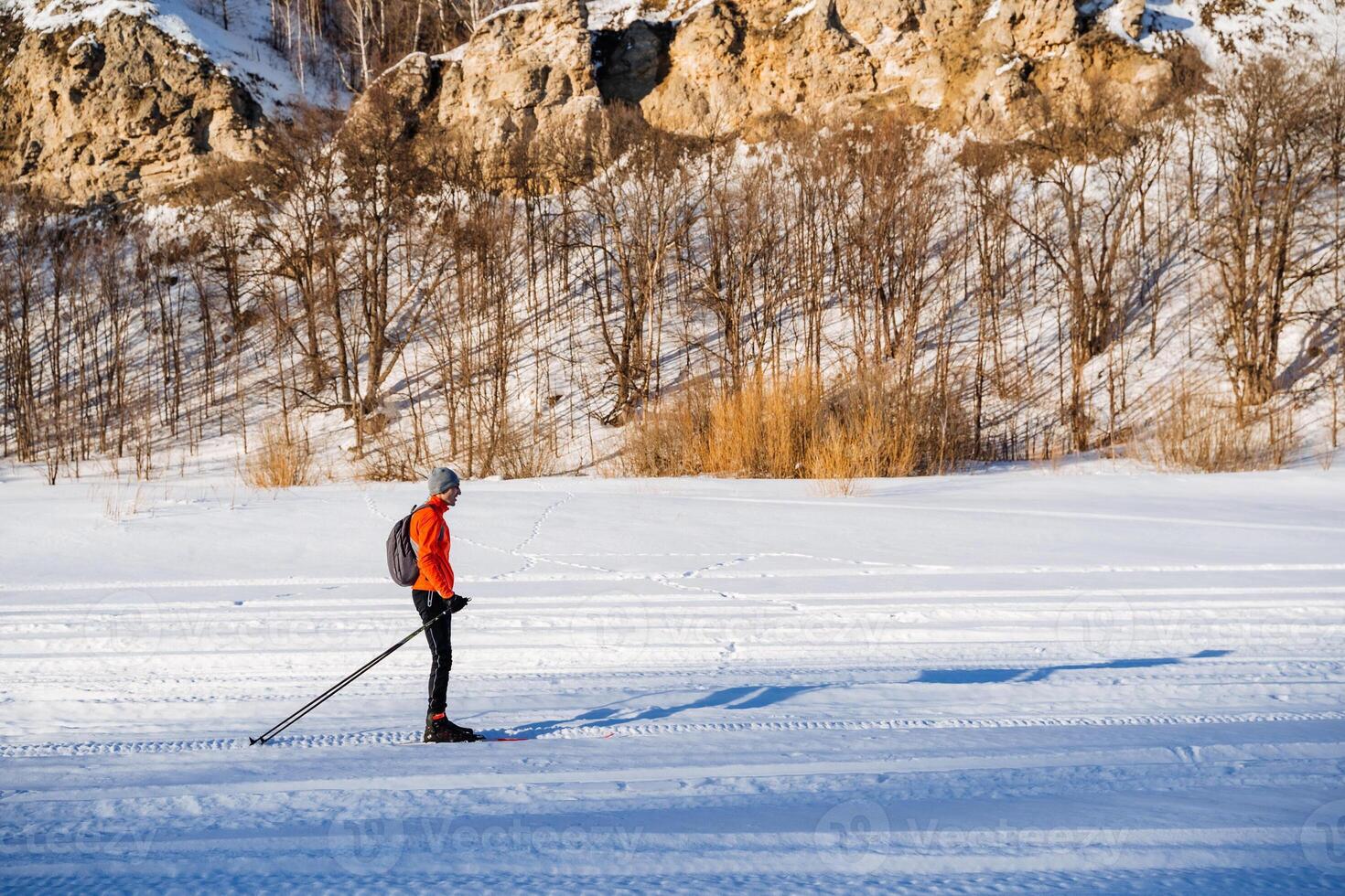 A man is cross country skiing on a snowy field photo