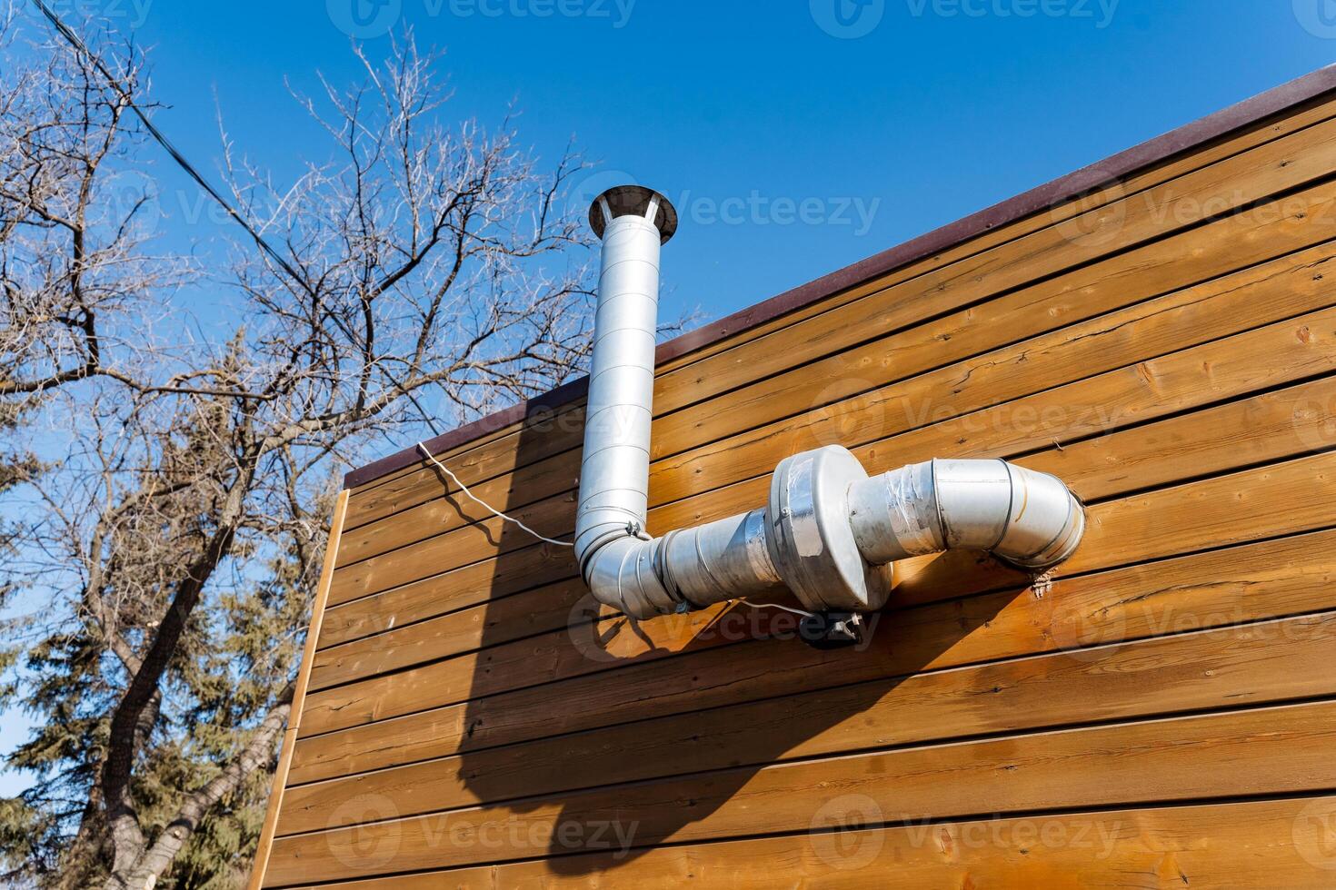 A metal pipe on the side of a building photo
