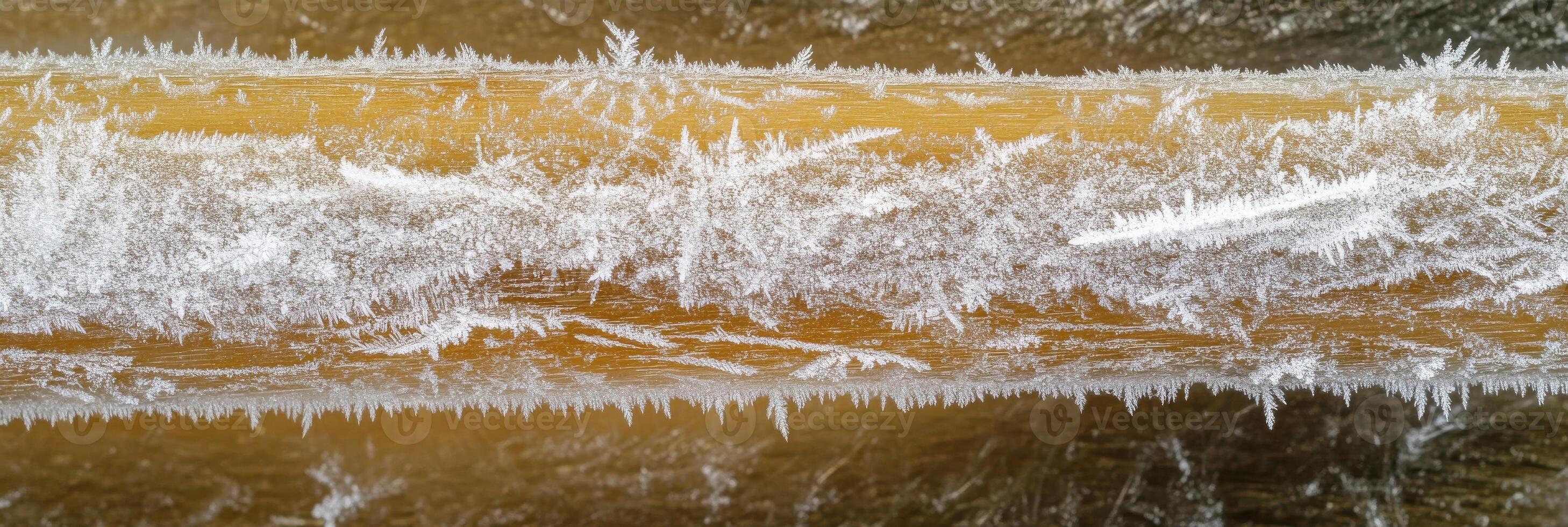 Close-up of ice crystals on wooden surface capturing natural patterns in winter photo