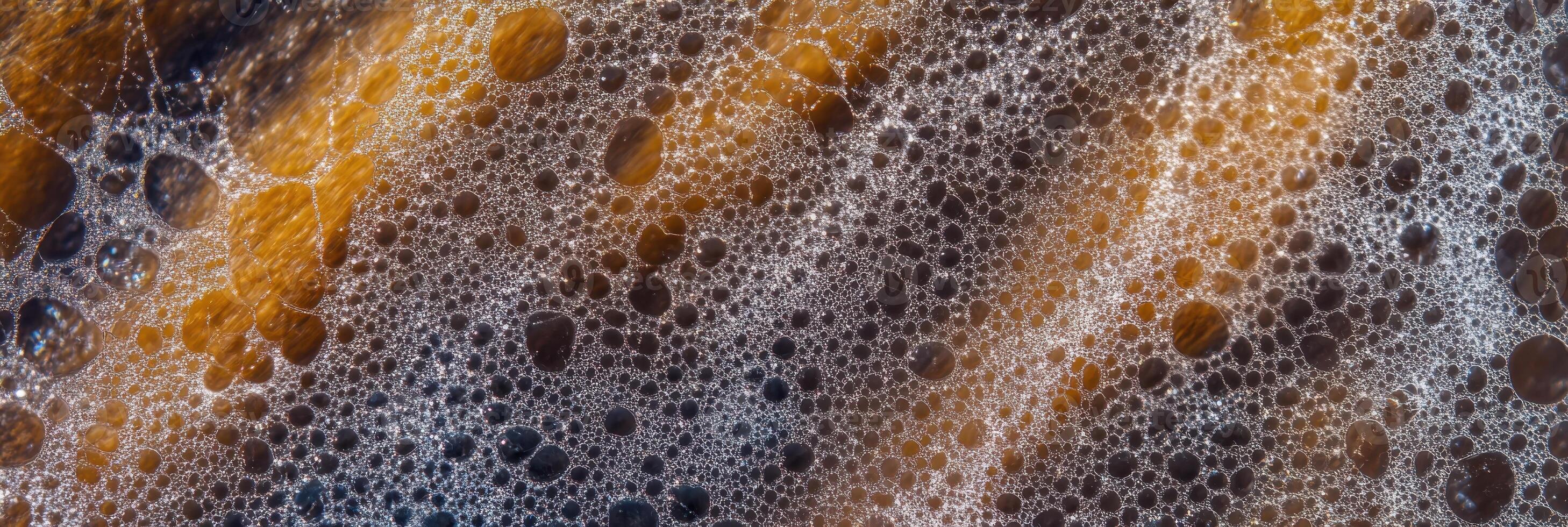 Close-up of coffee bubbles and foam with textured background photo