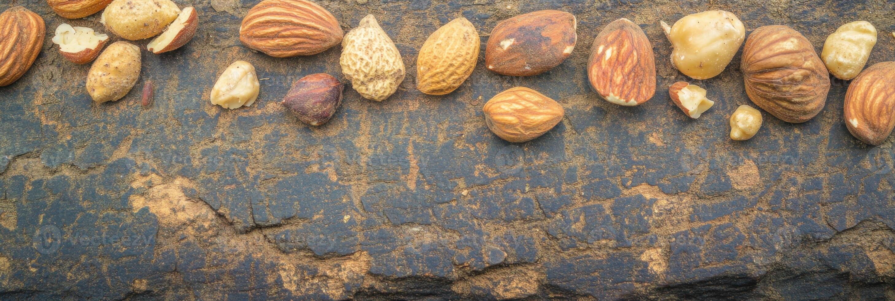 Variety of nuts and seeds arranged on a rustic stone surface for natural concept photo