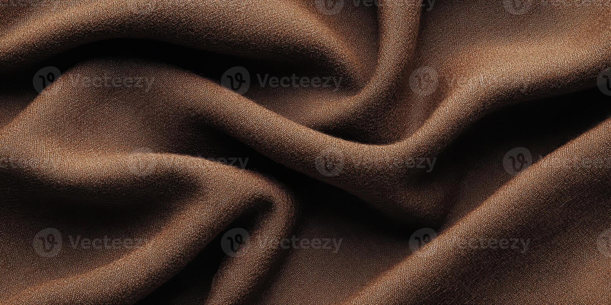 Close-up of smooth brown fabric with flowing folds for texture and surface background photo