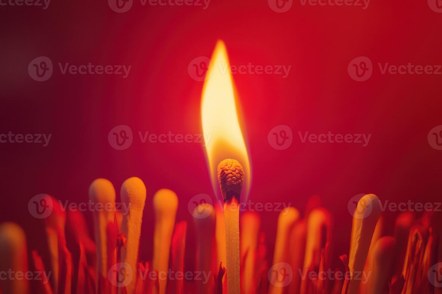 Burning matchstick with flame against red background symbolizing ignition and heat photo