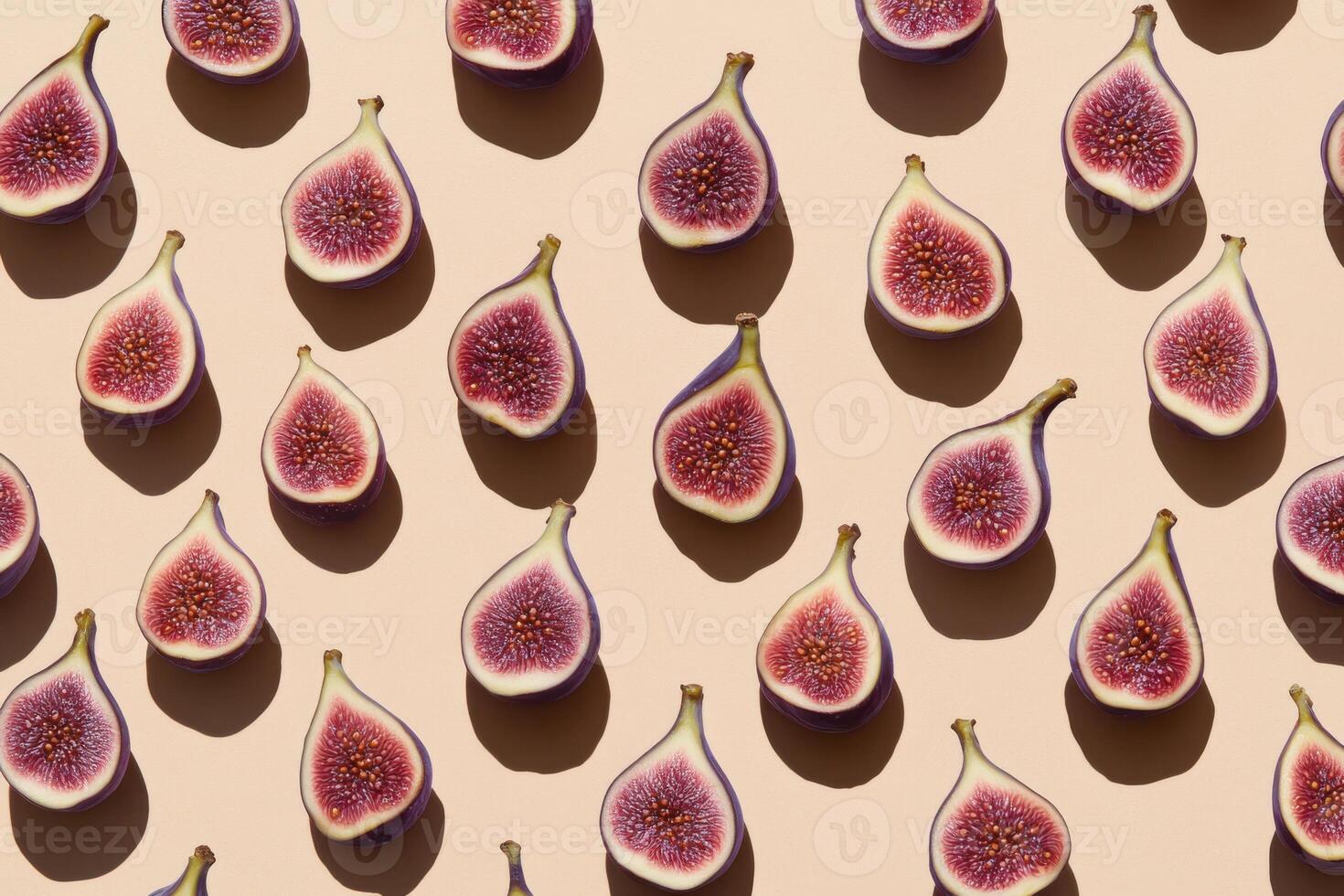 Sliced figs pattern on beige background in direct sunlight showcasing texture photo