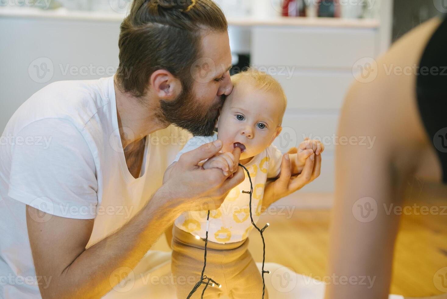 A Playful and Joyful Moment Between Father and Baby at Home Full of Love and Laughter photo