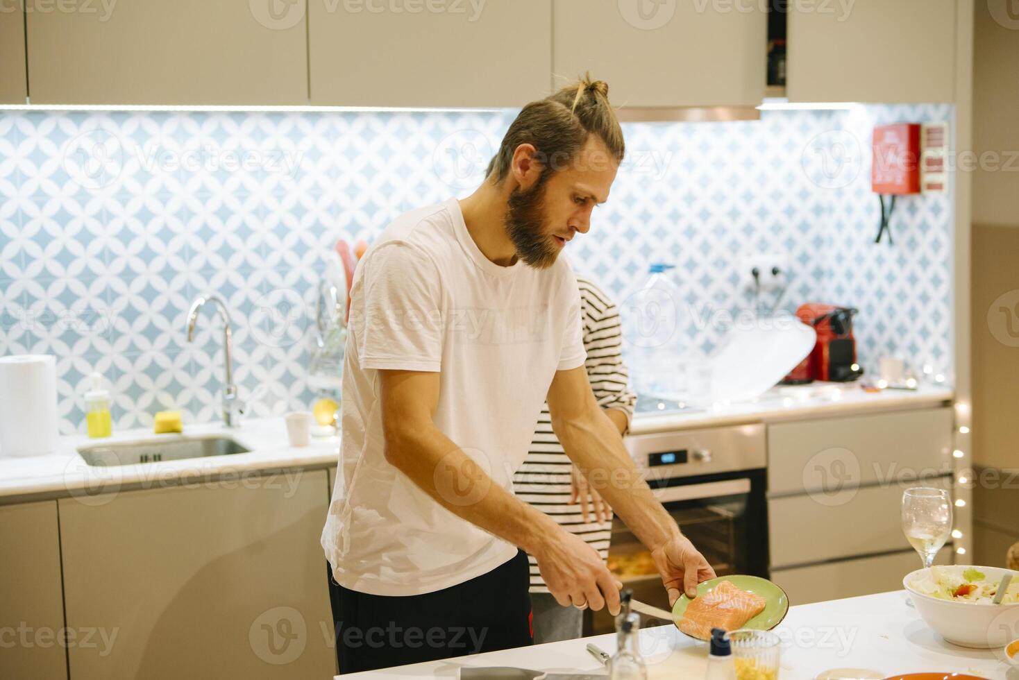Enjoying the delightful experience of cooking together in a modern and stylish kitchen photo