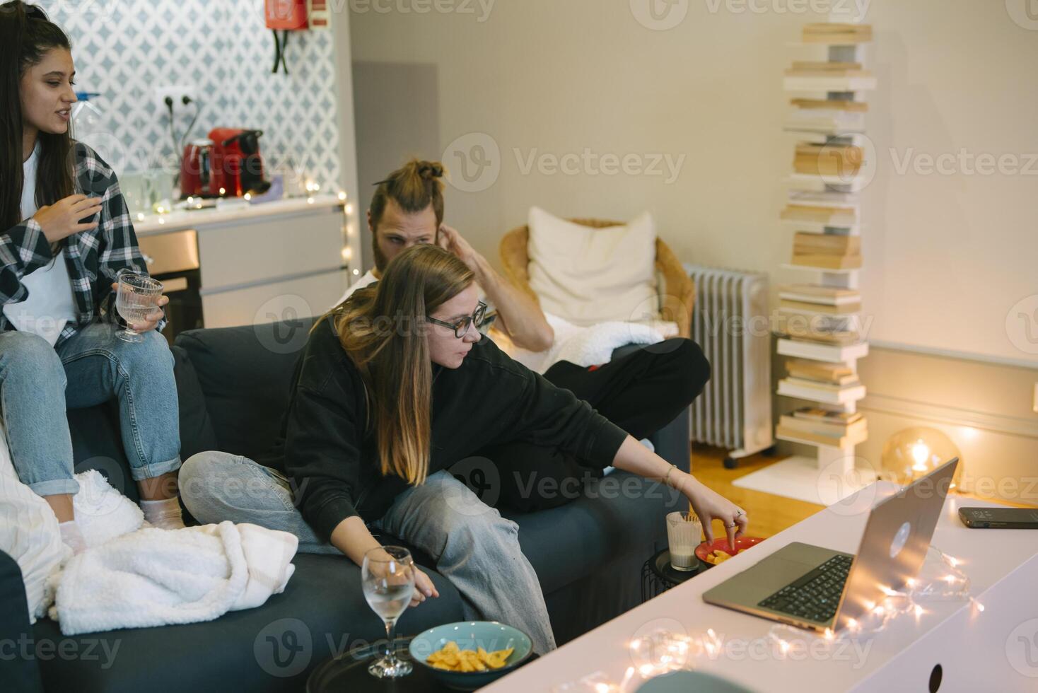 A Casual Gathering of Friends in a Cozy Living Room Surrounded by Delicious Snacks and Drinks photo