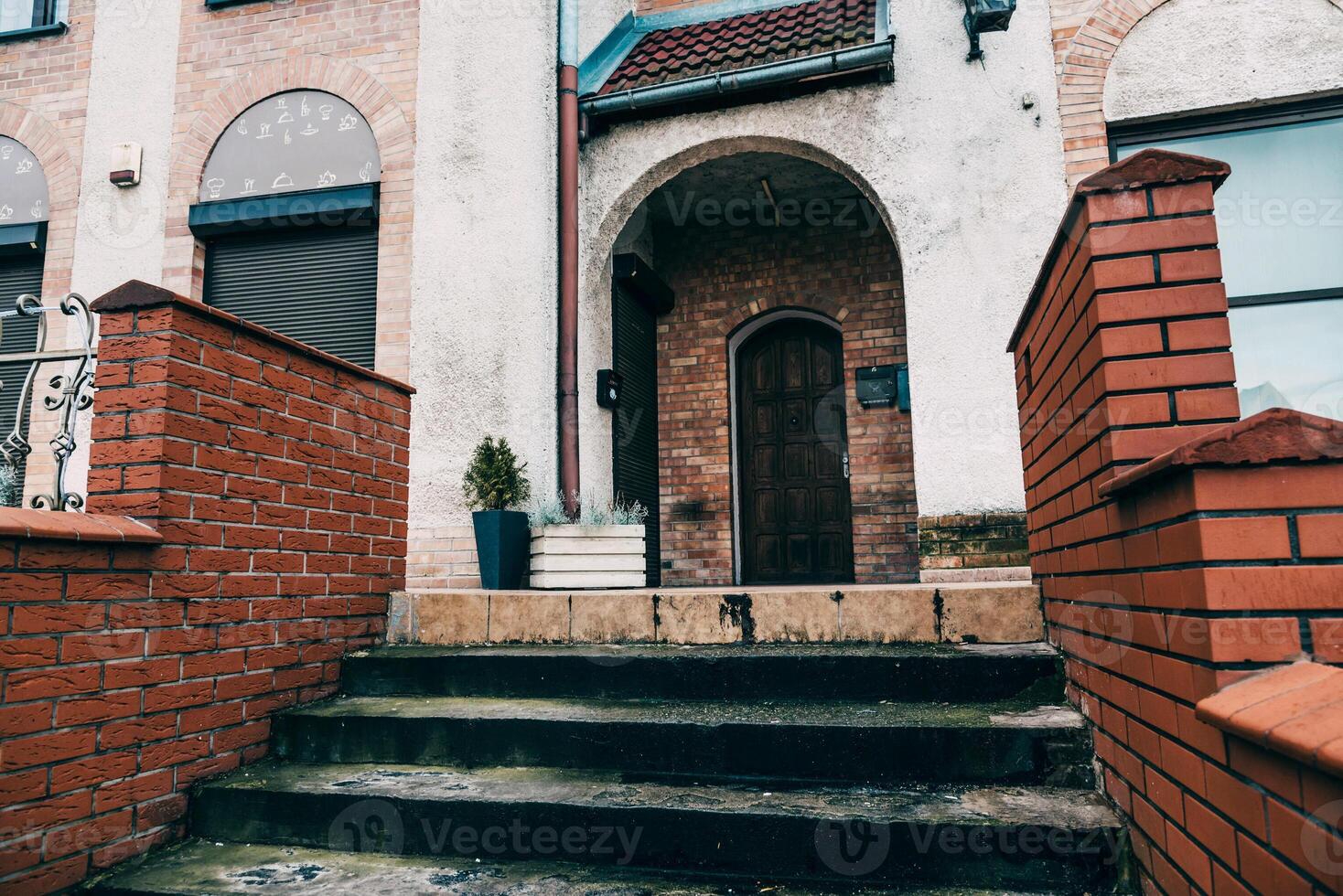 Stone concrete staircase in front of entrance to old European building photo