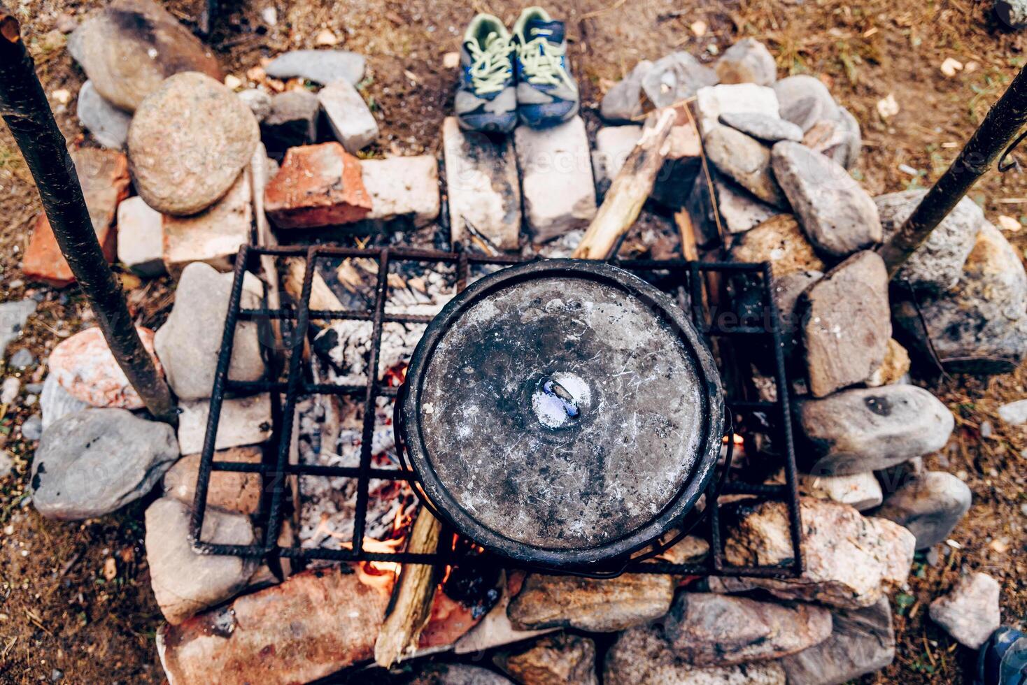 Camping Kitchen, Traveler nature Camp Cooking Food in Pots Campfire, tourist eat soup photo