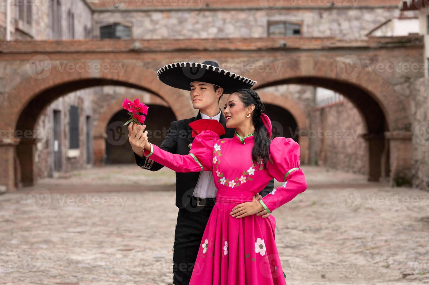 young hispanic woman and man in independence day or cinco de mayo parade or cultural Festival photo