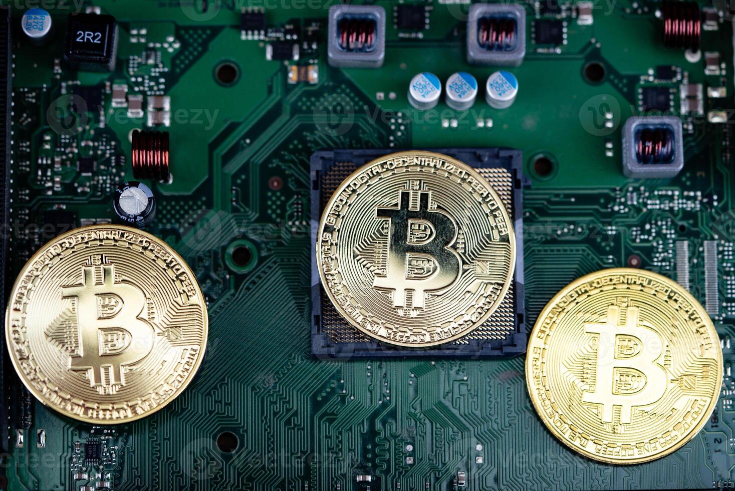 3 Bitcoins on a computer motherboard photo