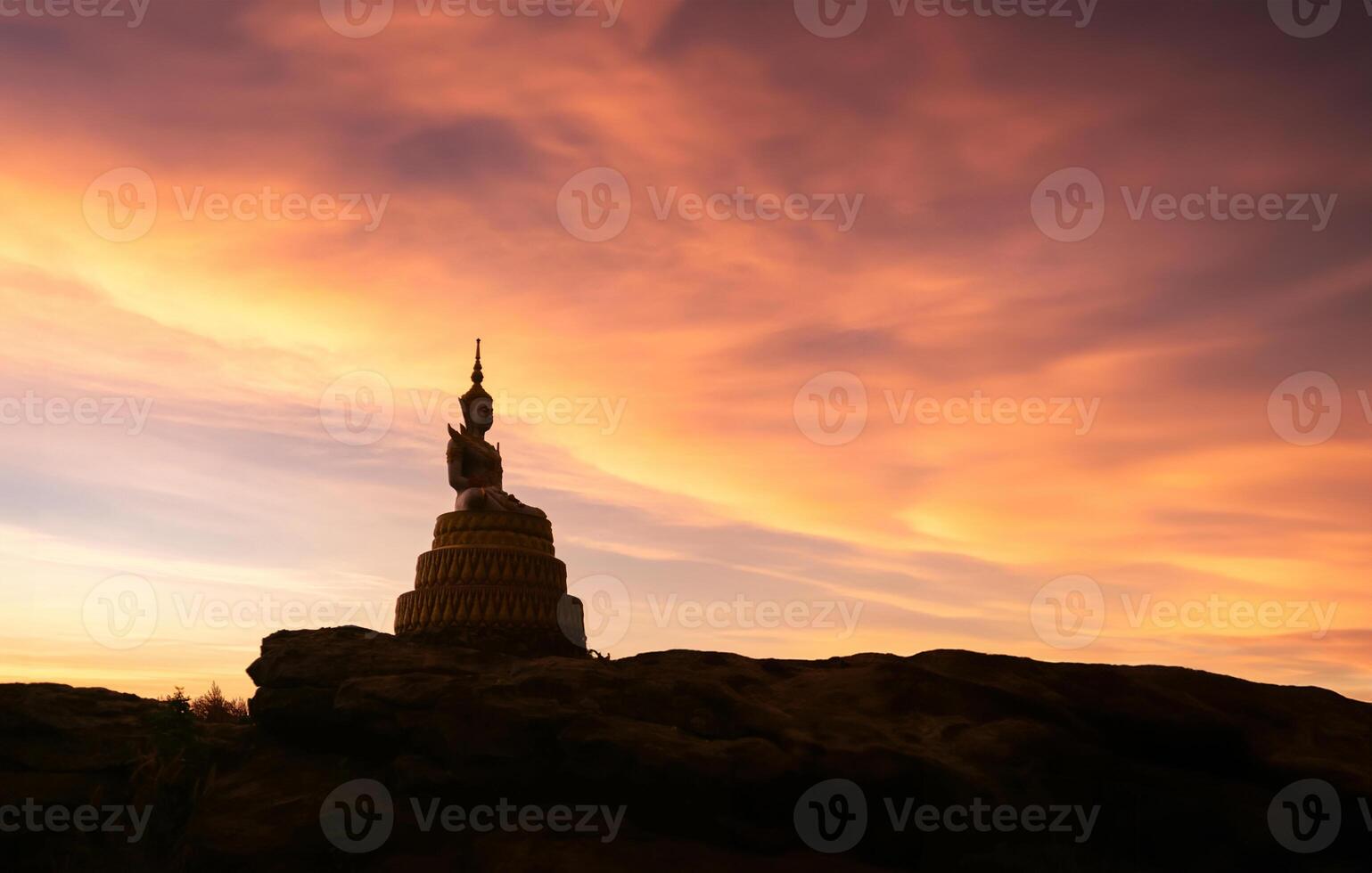 Buddha statue on the mountain in the morning light photo