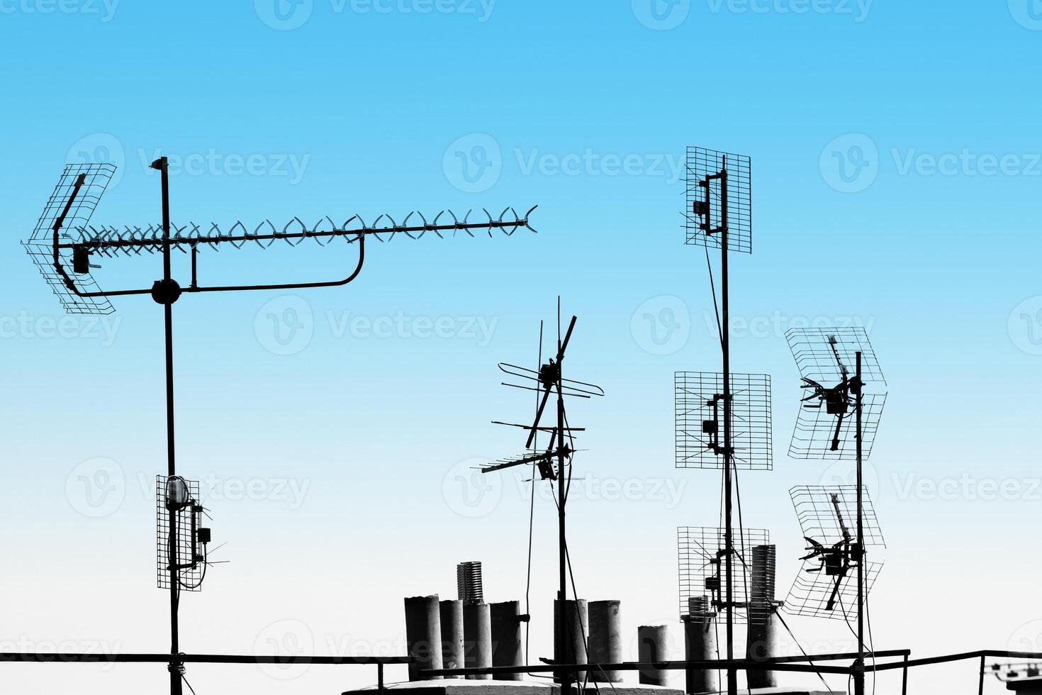 Antennas and pipes on top of the roof photo