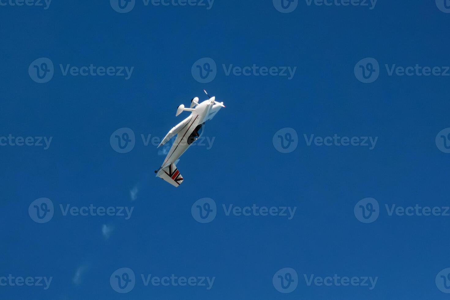 Stunt aerobatic plane performing stunts in air photo