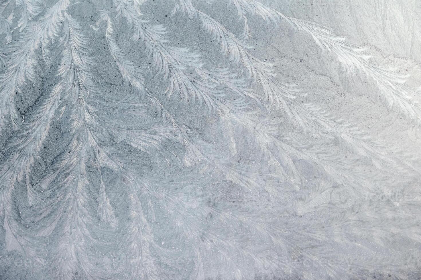 frost patterns on glass at subzero temperatures, abstract winter pattern,white lace pattern, photo