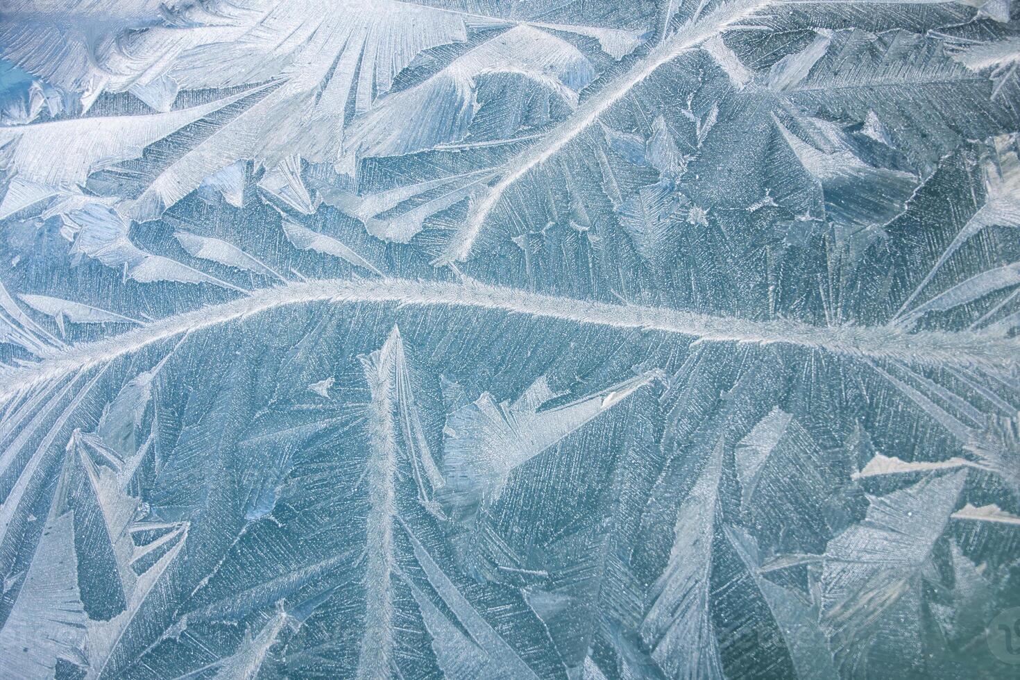 nature draws frost patterns on the glass with the freezing air temperature,abstract winter pattern photo