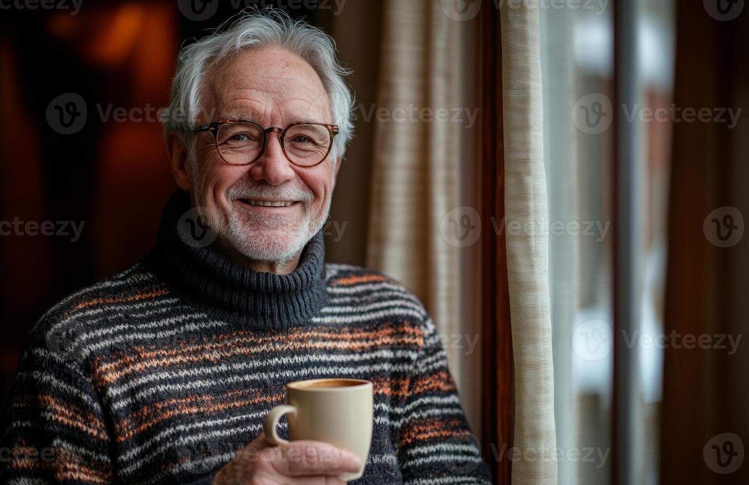 An older man with glasses and a sweater holding a cup photo