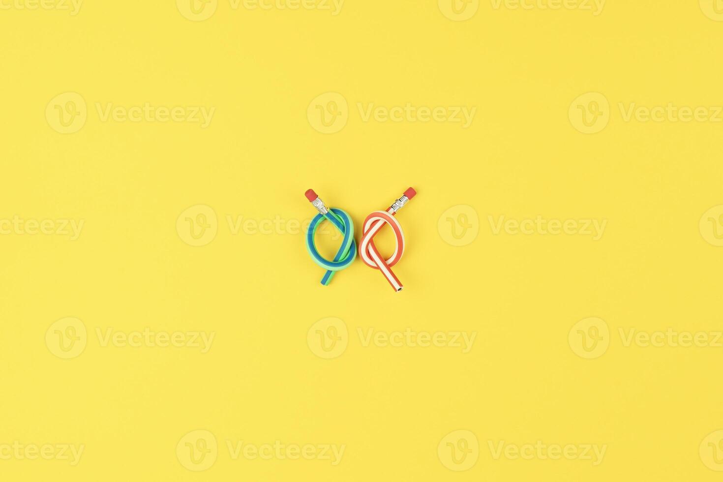 Knotted pencils on yellow background reflect stress in creative projects, stress in daily routines photo