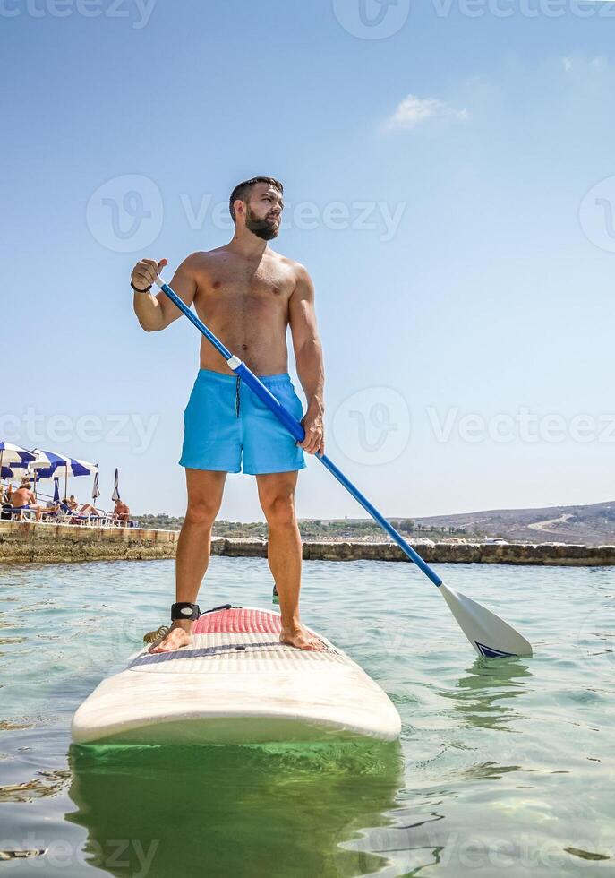 Beginner paddler on sup board photo