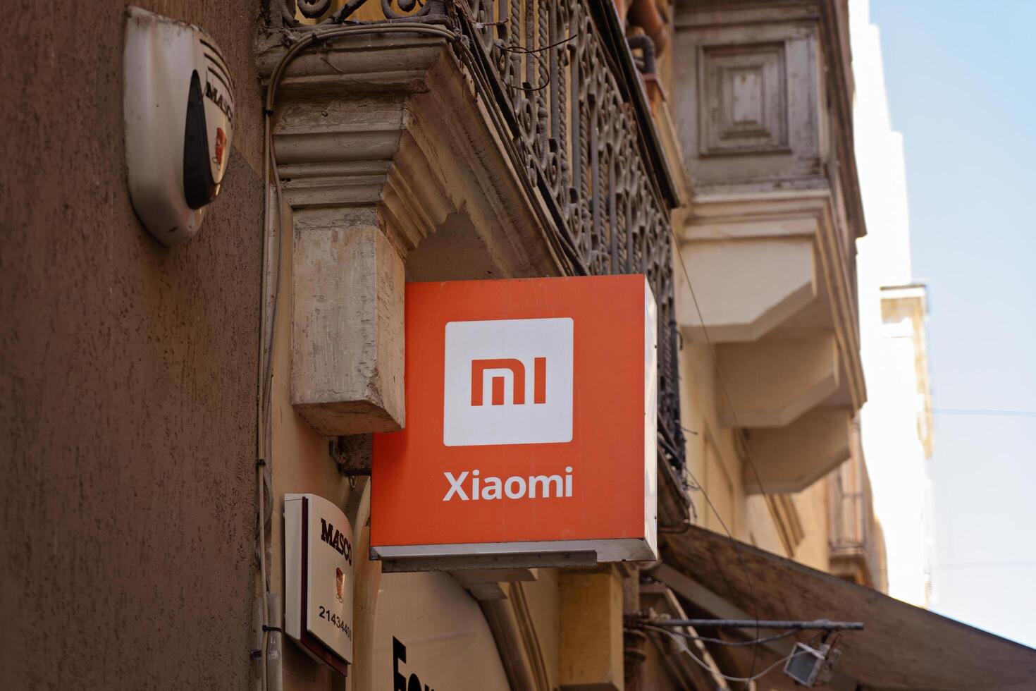 Valletta, Malta -February, 2024. Xiaomi Storefront Sign on Historic Building in Urban Setting photo