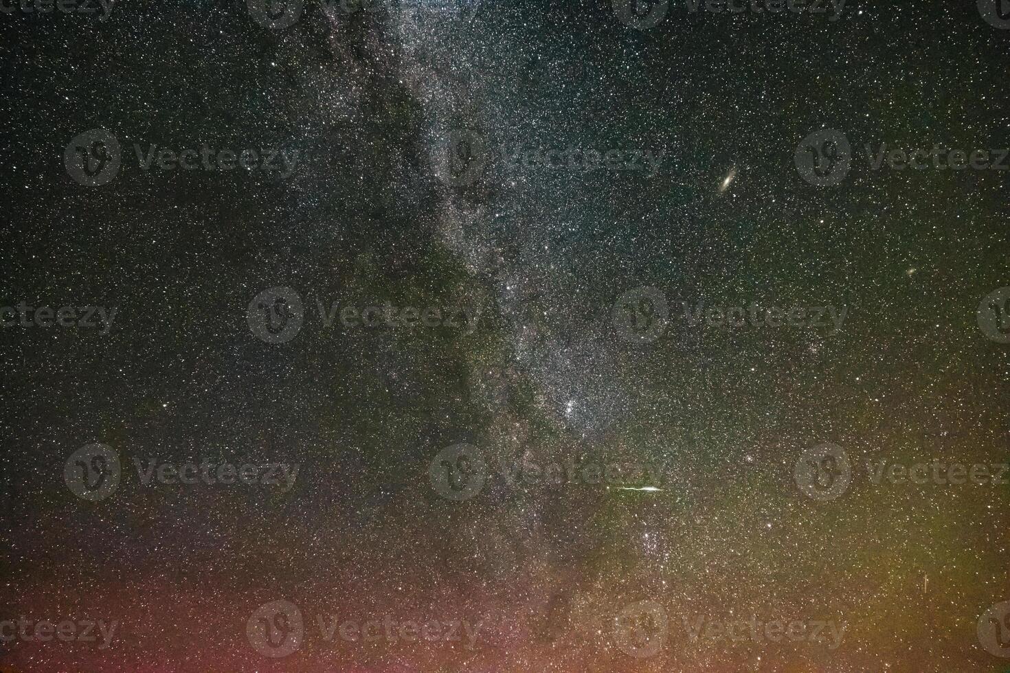 The Milky Way and andromeda galaxies with a meteor photo
